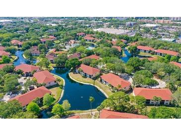 Scenic aerial view of a waterfront community with lush landscaping and multiple pools at 4325 46Th W Ave # 203, Bradenton, FL 34210
