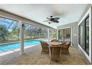 Inviting outdoor patio with screened in pool and lush landscaping, perfect for entertaining at 4917 Leatha Ln, Sarasota, FL 34232
