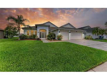Beautiful single-story home featuring a well-manicured lawn and lush landscaping at 5319 120Th E Ave, Parrish, FL 34219