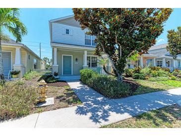 Charming two-story home featuring a manicured lawn and inviting front porch at 5420 River Sound Ter, Bradenton, FL 34208