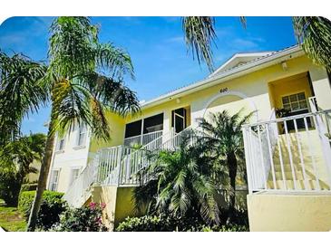 Charming condo with lush landscaping, including palm trees and well-maintained gardens in a desirable community at 600 Mirabella Cir # 201, Venice, FL 34292