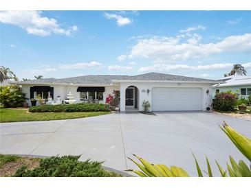 Charming single-story home featuring a well-maintained yard and an attached two-car garage at 965 E Gondola Dr, Venice, FL 34293