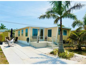 Charming home featuring a well-maintained exterior with a sunny patio and tropical landscaping at 1010 49Th W Ave, Bradenton, FL 34207