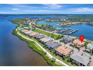 Breathtaking aerial view of waterfront homes, marina, and lush landscapes in a desirable coastal community at 1241 Riverscape St # B, Bradenton, FL 34208