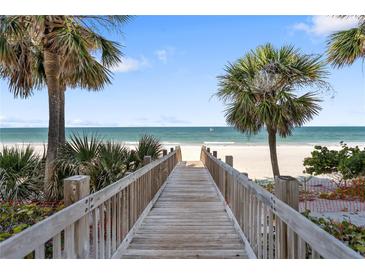 Wooden walkway to a beautiful beach with palm trees and stunning ocean views at 1800 Benjamin Franklin Dr # B1009, Sarasota, FL 34236