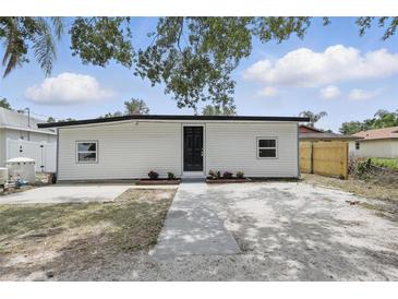 Charming single-story home featuring a black front door, white siding and minimal landscaping at 2652 26Th St, Sarasota, FL 34234