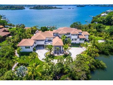 Expansive waterfront estate featuring lush landscaping and a private circular driveway at 3799 Flamingo Ave, Sarasota, FL 34242