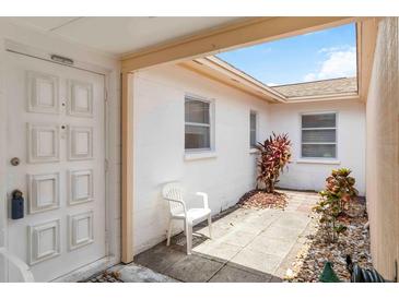 Front door leads to a bright entryway with courtyard, adding charm and natural light at 5062 White Oak Ct, Bradenton, FL 34207