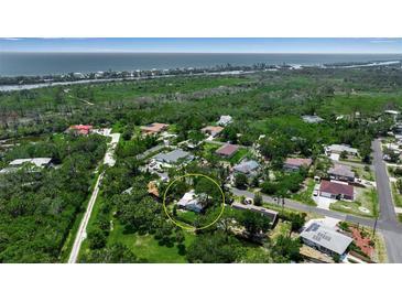 Beautiful aerial view of home near the ocean with lush green landscaping at 951 Varet Rd, Venice, FL 34293