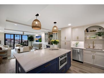 Bright, open kitchen with a center island and modern appliances, adjacent to an airy living space at 2045 Gulf Of Mexico Dr # M1-505, Longboat Key, FL 34228