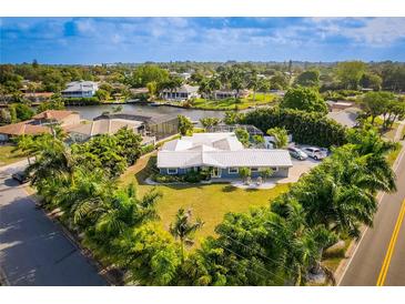 Waterfront property with beautiful landscaping, complemented by a stunning home exterior and boat dock at 2159 Constitution Blvd, Sarasota, FL 34231