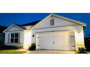 Charming single-story home featuring a two-car garage and meticulously maintained landscaping at 2410 Mizner Bay Ave, Bradenton, FL 34208