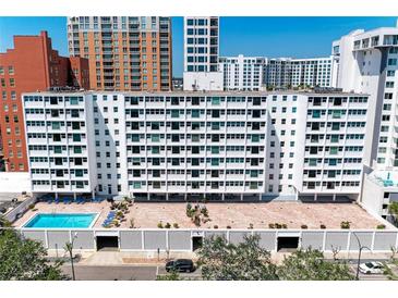 Apartment complex with a pool and an entrance with a bricked drive and mature landscaping at 33 S Gulfstream Ave # 306, Sarasota, FL 34236