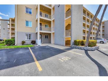Multi-story condo building with assigned parking space, well-maintained landscaping, and private balconies overlooking the property at 3521 Lake Bayshore Dr # 3521, Bradenton, FL 34205