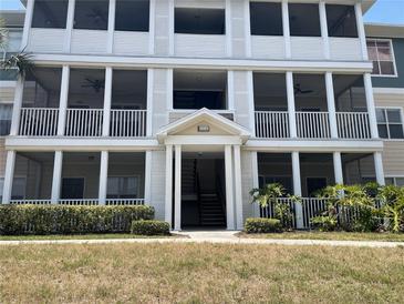 Three-story condo building featuring screened-in porches and well-maintained landscaping at 4802 51St W St # 1724, Bradenton, FL 34210