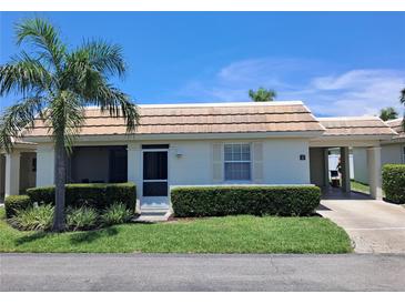 Charming one-story home with a well-manicured lawn and a covered carport, perfect for relaxed living at 6150 Midnight Pass Rd # V4, Sarasota, FL 34242