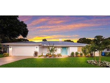 Beautiful single-story home featuring a well-manicured lawn and a striking blue front door at 1915 38Th W St, Bradenton, FL 34205