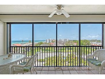 Enjoy the ocean view from this screened balcony with wicker furniture and beautiful tile flooring at 2045 Gulf Of Mexico Dr # M1-515, Longboat Key, FL 34228