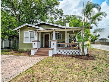 Charming bungalow-style home featuring a covered front porch and well-maintained landscaping at 301 W South Ave, Tampa, FL 33603