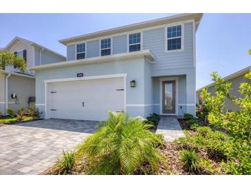 Charming two-story home features a two-car garage, beautiful landscaping, and a welcoming entrance at 4524 Pippin Ln, Lakewood Ranch, FL 34211