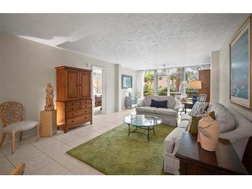 Inviting living room with serene decor, plush sofas, and a view to the lanai at 4530 Pinebrook Cir # 109, Bradenton, FL 34209