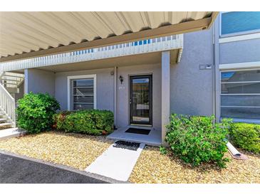 Charming condo entrance with landscaped garden and covered doorway at 6108 7Th W Ave # 6108, Bradenton, FL 34209