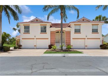 Charming townhome with a red-tile roof, white exterior and two-car garage at 7532 Marsh Orchid Cir # 8-201, Bradenton, FL 34203