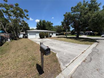 Charming single-story home with a lush front yard and a double-wide driveway on a sunny day at 8291 57Th N St, Pinellas Park, FL 33781