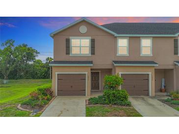 Charming townhome featuring a well-maintained lawn, garage, and inviting curb appeal at 1053 Grantham Dr, Sarasota, FL 34234