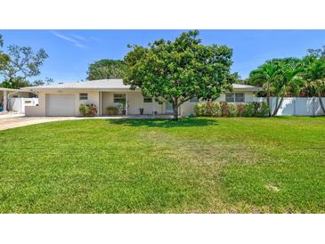 Charming single-story home with a well-manicured lawn and mature shade tree at 1324 Augusta S Ln, St Petersburg, FL 33707