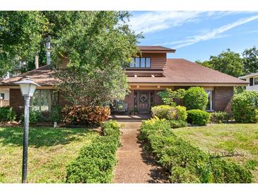 Charming two-story home with a well-manicured front yard and a welcoming front porch at 1671 South Dr, Sarasota, FL 34239