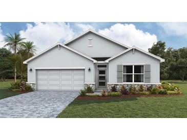 Charming single-story home with stone accents, a two-car garage, and well-manicured landscaping at 1754 Cobb Trl, Parrish, FL 34219