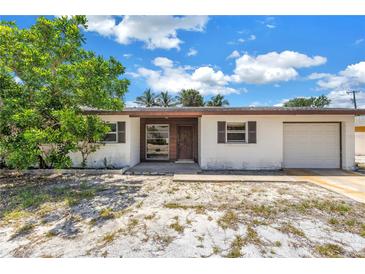 Charming single-story home features a one-car garage and a simple front landscape at 310 Avenida Milano, Sarasota, FL 34242