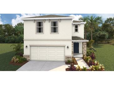 Two-story home featuring a two-car garage, landscaped yard and a welcoming front entryway at 3215 Bitterroot Ln, Lakewood Ranch, FL 34211