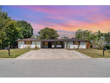 Charming single-story home with a spacious driveway and well-maintained landscaping at 3921 Marlborough Pl, Sarasota, FL 34241