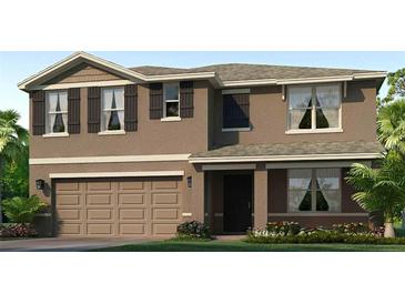Charming two-story home featuring a two-car garage, landscaped yard, and a welcoming front entrance at 4403 Dusky Dawn Ln, Palmetto, FL 34221