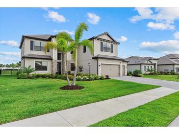 Beautiful two-story home with a well-manicured lawn and lush landscaping under a cloudy sky at 15315 Golden Beam Pl, Bradenton, FL 34211