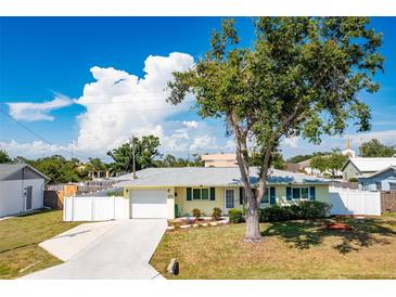 Charming single-story home with a well-maintained lawn, mature tree, and attached one car garage at 4375 Tortoise Rd, Venice, FL 34293