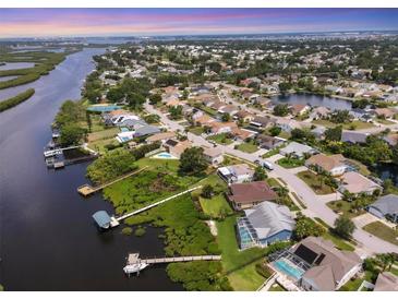 Scenic aerial view of waterfront homes, docks, and lush landscaping along the canal and neighborhood at 4844 14Th E Ave, Bradenton, FL 34208