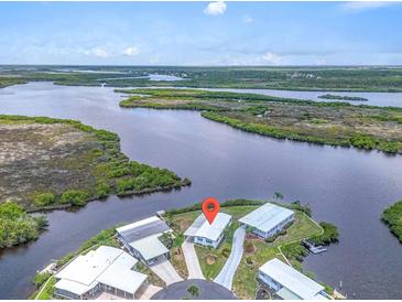 Stunning aerial view of waterfront home with private dock and lush landscaping at 550 Tampico Dr, North Port, FL 34287