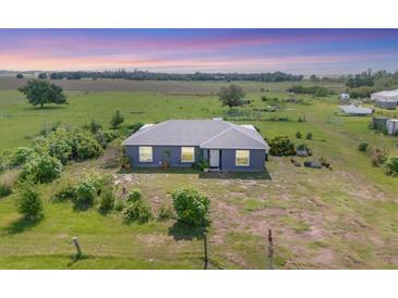 Aerial view of a well-kept home with a large front yard in a rural setting at 7745 Wauchula Rd, Myakka City, FL 34251