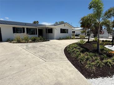 Beautifully landscaped home featuring a curved driveway with well-manicured plants and fresh white gravel at 808 25Th W Ave, Palmetto, FL 34221