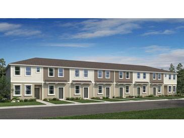 New townhome building with neutral siding, a dark roof, and well-manicured front lawns on a sunny day at 8592 Daybreak St, Sarasota, FL 34241