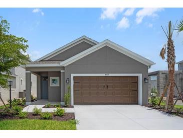 Charming single-Gathering home with a two-car garage, landscaped yard and covered entryway at 8632 Snowfall St, Sarasota, FL 34241