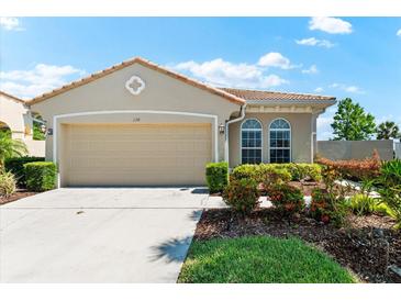 Charming single-story home with manicured landscaping and a two-car garage at 138 Tiziano Way, North Venice, FL 34275