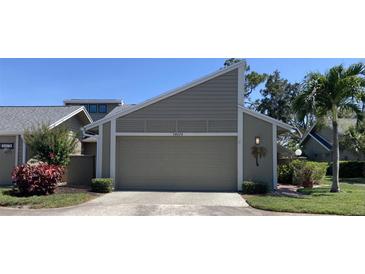 Charming home with an attached garage, well-maintained landscaping, and a lovely palm tree in the front yard at 3407 Avenida Madera # A, Bradenton, FL 34210
