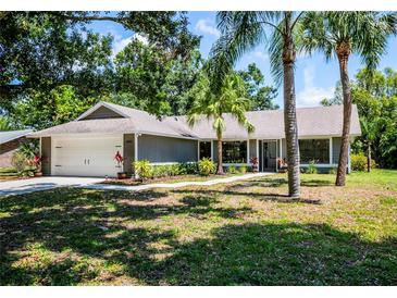 Charming single-story home featuring lush landscaping, a two-car garage, and a welcoming front entrance at 4253 Prairie View Dr, Sarasota, FL 34232
