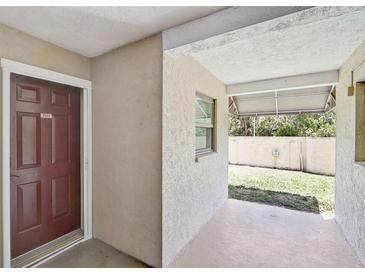 Inviting front porch with a covered area, perfect for enjoying the outdoors at 7211 Cloister Dr # 101, Sarasota, FL 34231