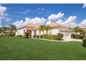 Charming single story home with a well-manicured lawn, tile roof, and attached two-car garage at 7432 Birds Eye Ter, Bradenton, FL 34203