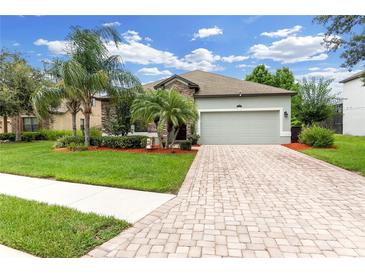 Beautiful single-story home featuring a two-car garage, stone accents, and lush landscaping at 2334 50Th Street E Cir, Palmetto, FL 34221